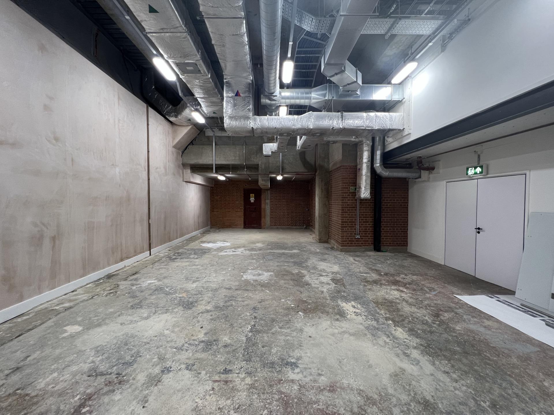 plant-room corridor — bare brick to white walls and resin floor — Existing
